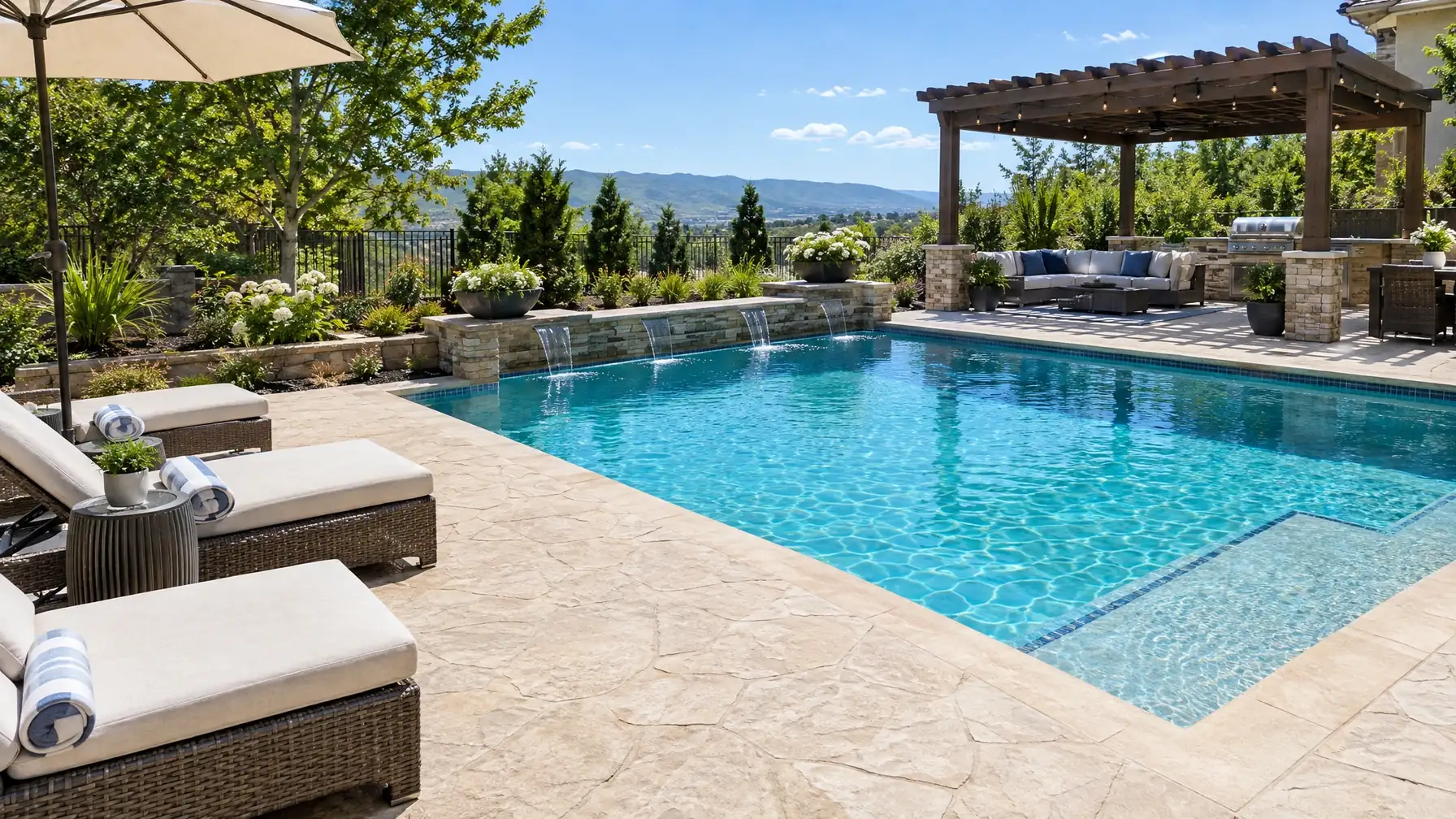 Stamped concrete cool deck around a backyard pool with lounge chairs