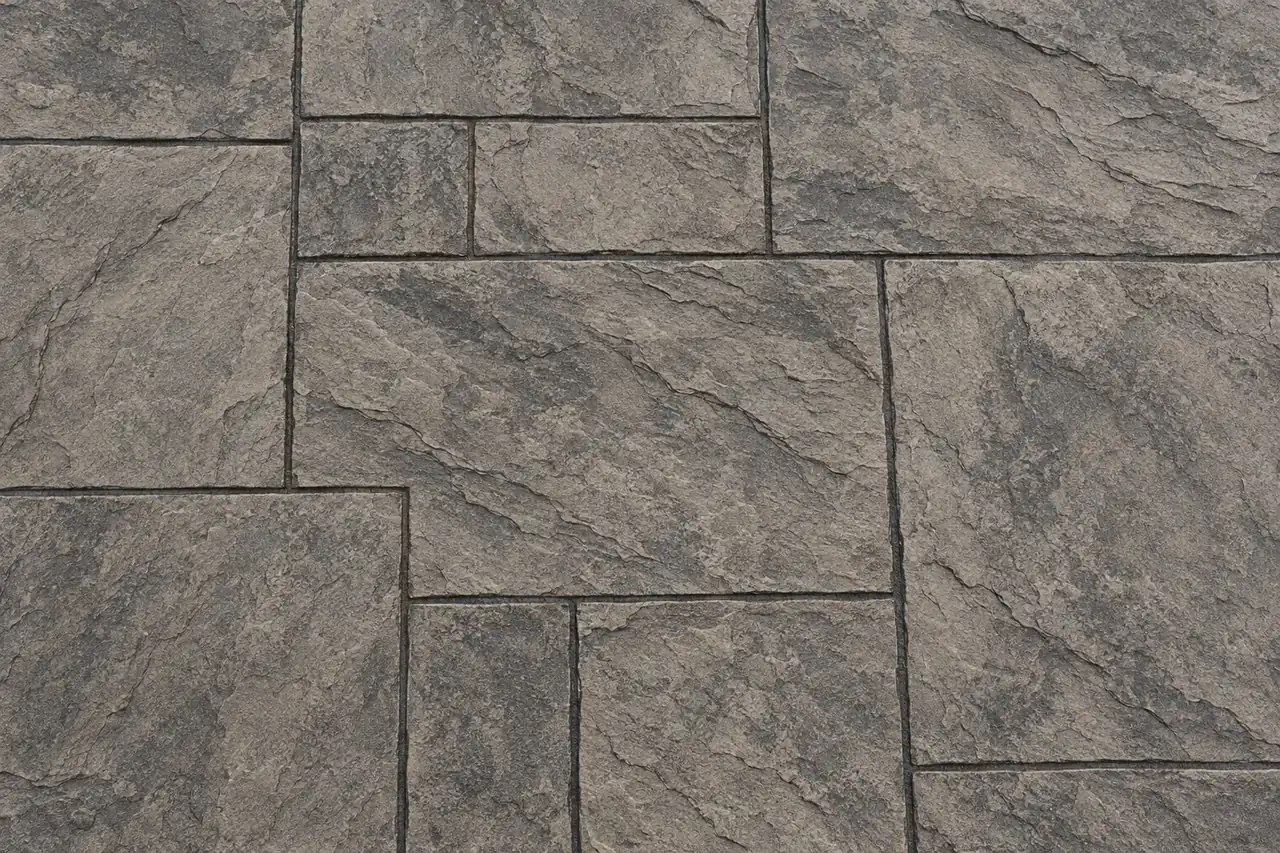 Top-down view of ashlar slate stamped concrete in warm gray with charcoal release