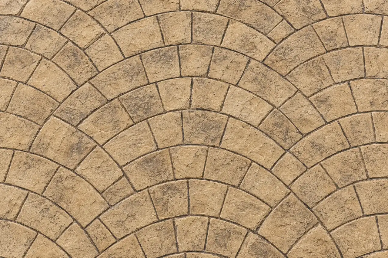 Top-down view of European fan stamped concrete in sandstone beige with dark antique release